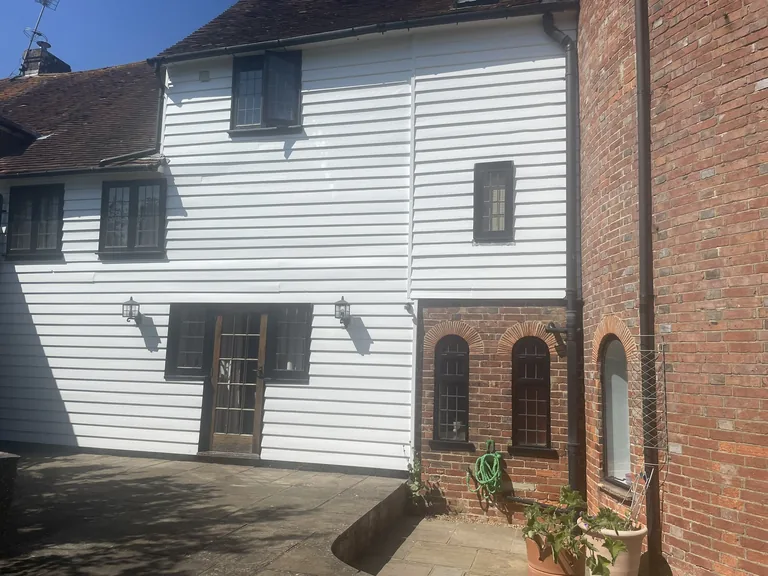 Completed weatherboard restoration on the rear elevation of a Grade II listed oast house in Northiam near Rye